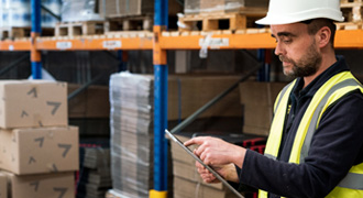 Factory worker stock checking automation parts.